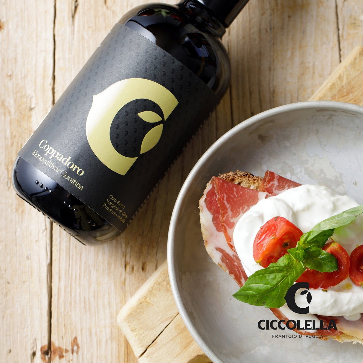 Olivenölflasche, Brot mit Schinken, Tomaten, Basilikum, Ciccolella-Logo.