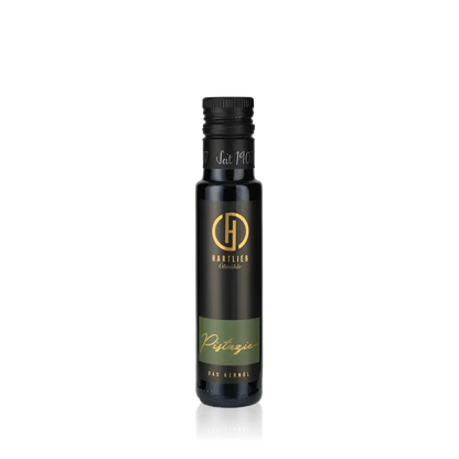 Hartlieb Pistazienöl Flasche auf schwarzem Hintergrund.