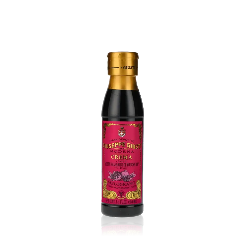 Giuseppe Giusti Crema Granatapfel Balsamicocreme Flasche auf schwarzem Hintergrund.