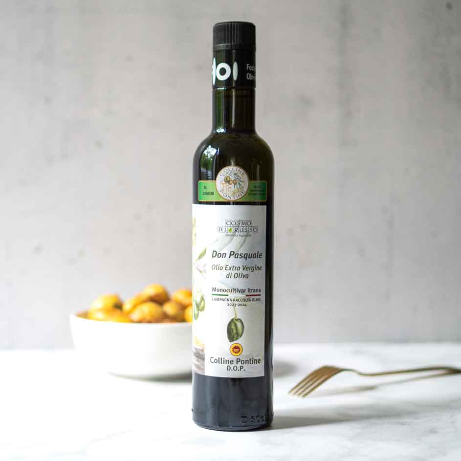 Olivenölflasche Don Pasquale vor Schüssel mit Oliven.