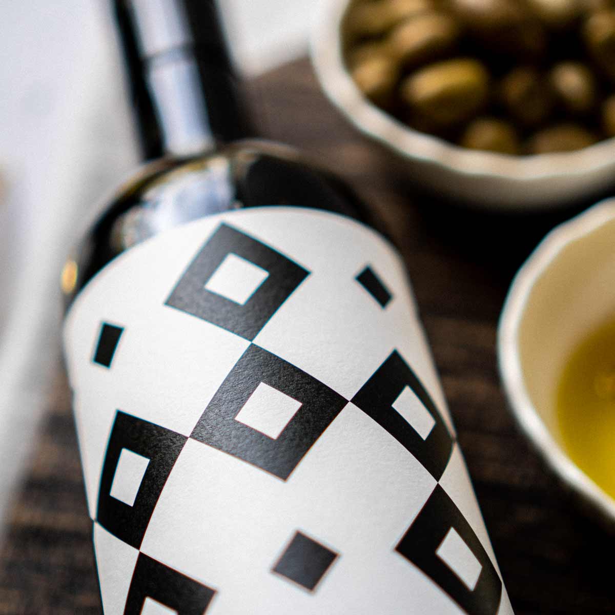 Flasche Olivenöl, Schalen mit Oliven und Öl.