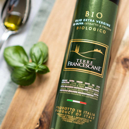 Terre Francescane Bio Olivenölflasche auf Holzuntergrund.